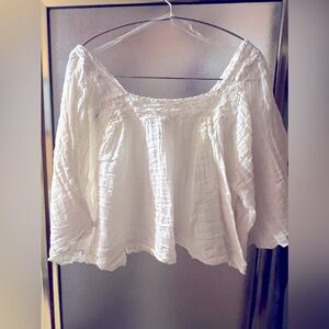 Flowing white top with Crocheted like lace accents.